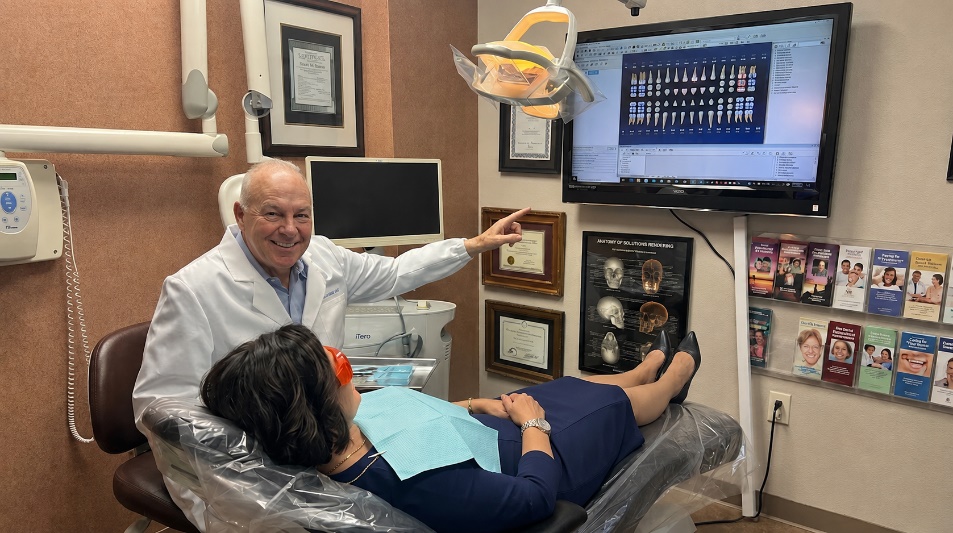 Dr. Douglas R. Maxson talking with a patient at Calm Dental Care in San Jose