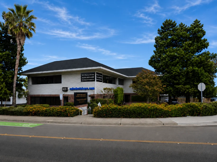 The Calm Dental Care building on S De Anza Boulevard in San Jose, on a sunny day with palm trees and landscaping
